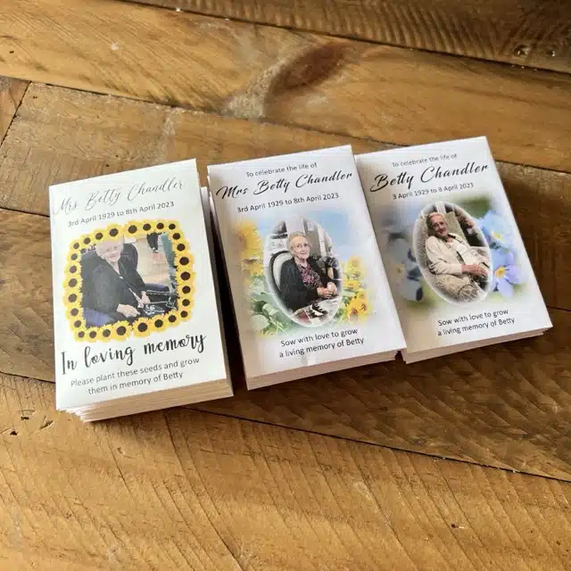 Selection of white envelopes showing various personalised portrait designs using sunflower and forget me not seeds